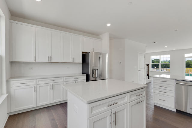 1627 Sager Way Batavia, IL 60510 - Photo 7 of 25 a kitchen with white cabinets and stainless steel appliances