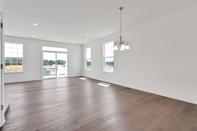 1627 Sager Way Batavia, IL 60510 - Photo 9 of 25 an empty room with wooden floor and windows