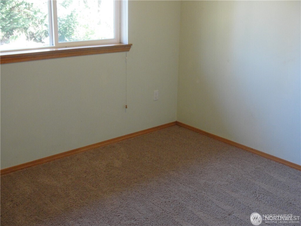 1664 Spruce Ridge Drive Camano Island, WA 98282 - Photo 11 of 24 a view of a small space with wooden floor and a window