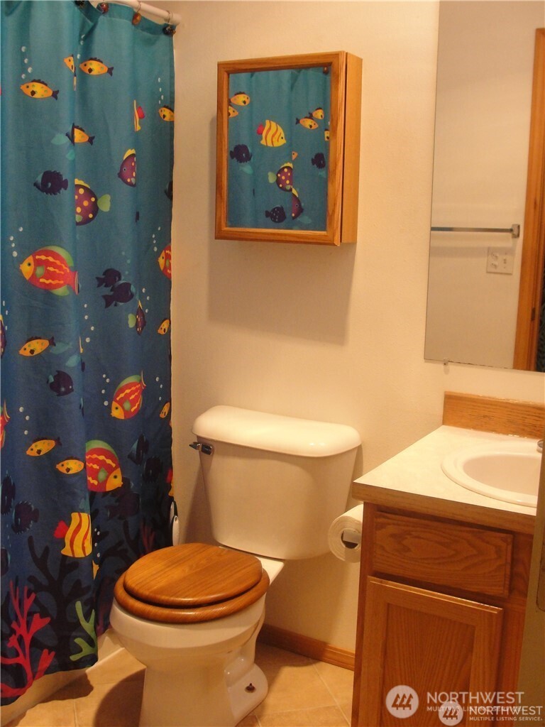 1664 Spruce Ridge Drive Camano Island, WA 98282 - Photo 12 of 24 a white toilet sitting next to a sink