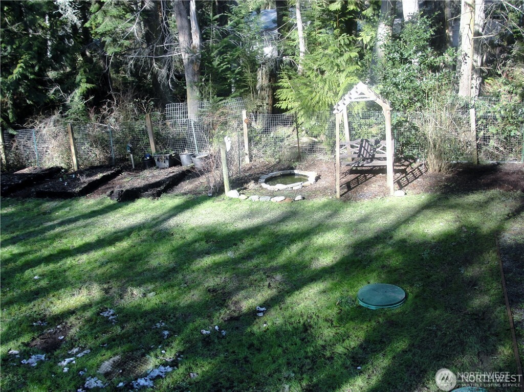 1664 Spruce Ridge Drive Camano Island, WA 98282 - Photo 16 of 24 a backyard of a house with table and chairs