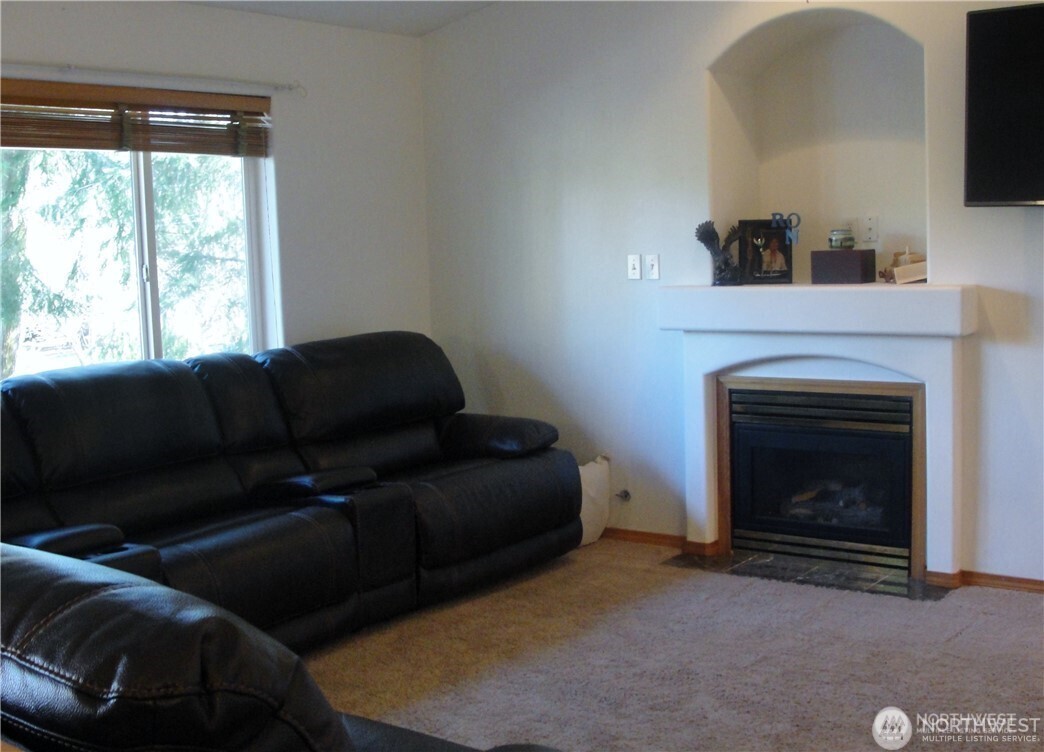 1664 Spruce Ridge Drive Camano Island, WA 98282 - Photo 3 of 24 a living room with furniture and a fireplace