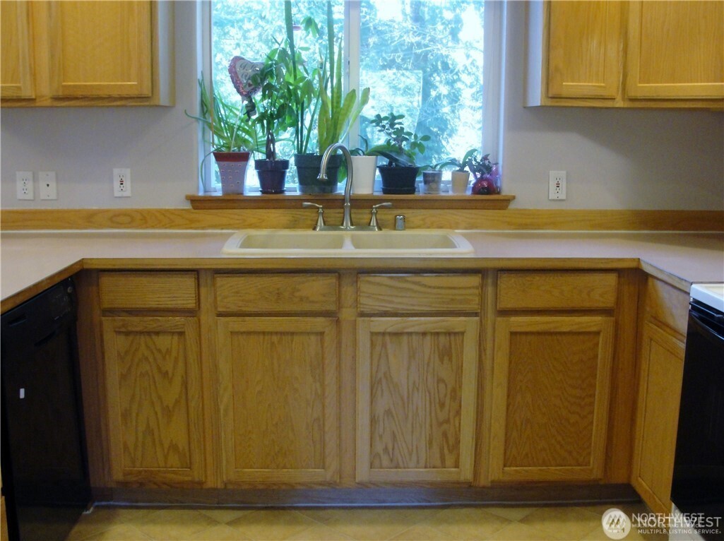 1664 Spruce Ridge Drive Camano Island, WA 98282 - Photo 6 of 24 a view of a sink and potted plant in a kitchen