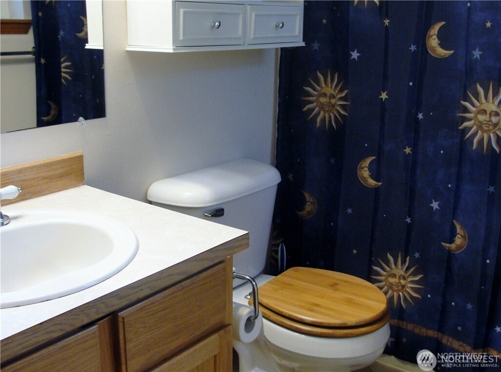 1664 Spruce Ridge Drive Camano Island, WA 98282 - Photo 9 of 24 a bathroom with a sink a toilet and a mirror
