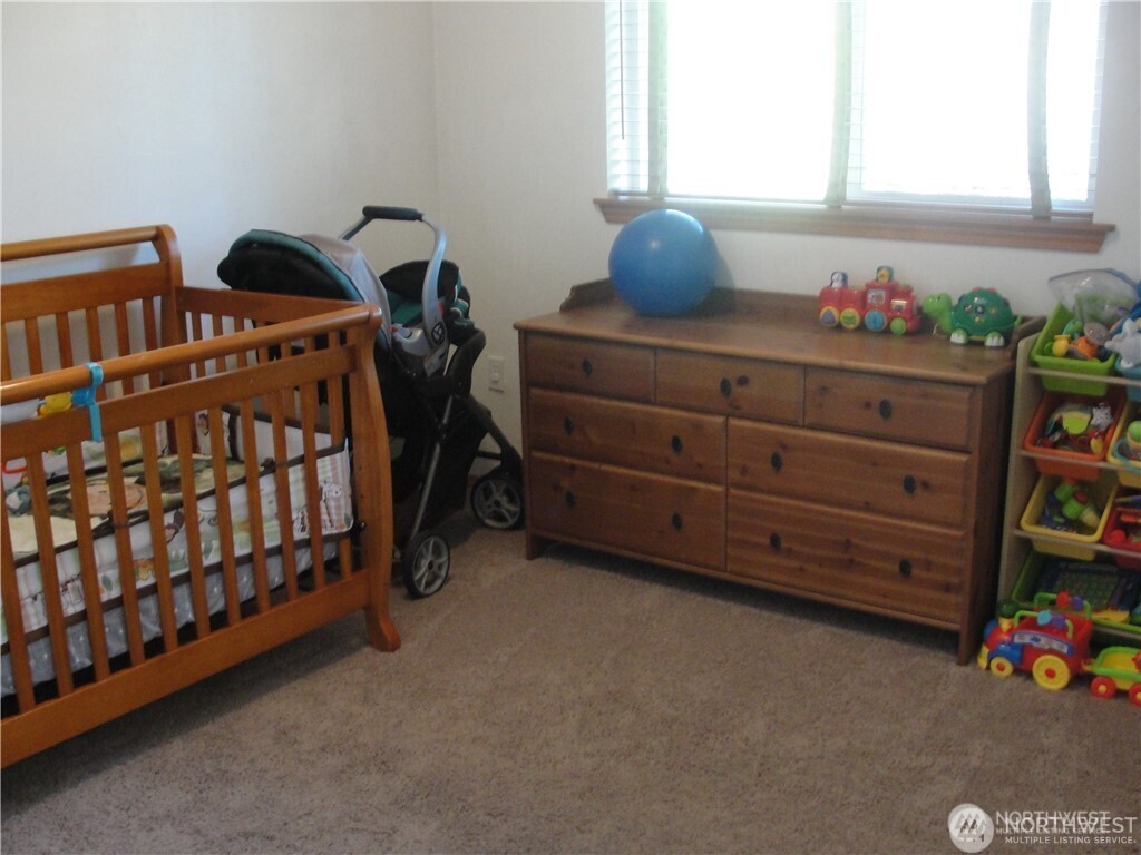 1664 Spruce Ridge Drive Camano Island, WA 98282 - Photo 10 of 24 a bedroom with a bed and a window