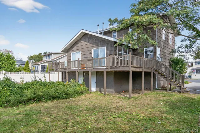 a front view of a house with a yard and potted plants