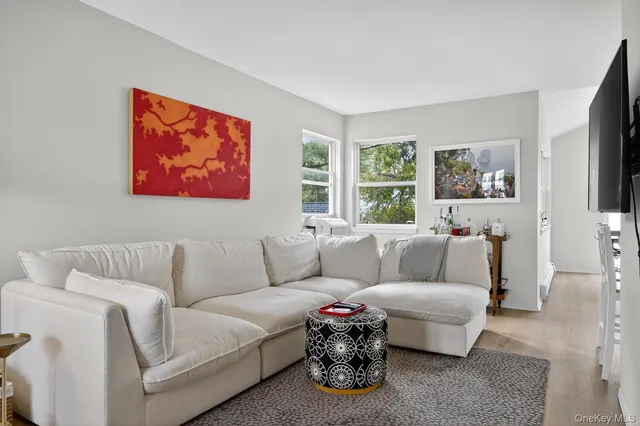 a living room with furniture a couch and a flat screen tv