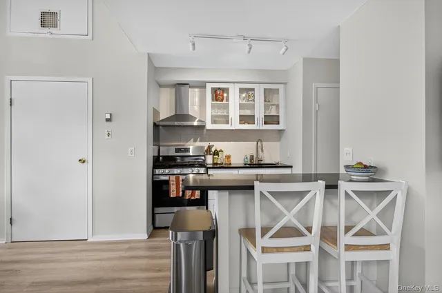 a kitchen with stainless steel appliances granite countertop a stove and a refrigerator