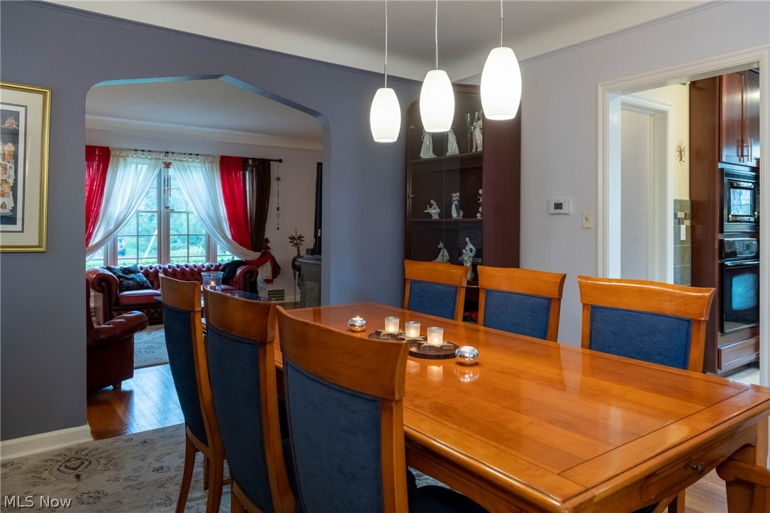 3433 Bradford Road Cleveland, OH 44118 - Photo 12 of 35 Newer Pendant lighting accents the archway & freshly painted walls of this Living/Dinning rm combo. Perfect for entertaining or a cozy night in.