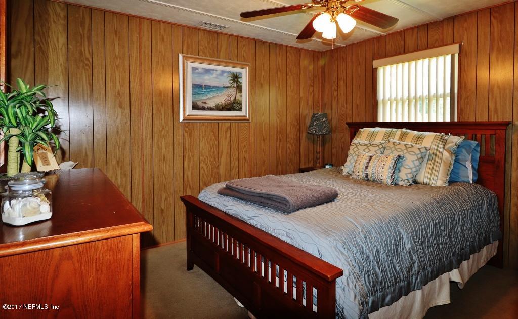 10414 Stone Road Jacksonville, FL 32246 - Photo 14 of 23 a bedroom with a bed and a potted plant