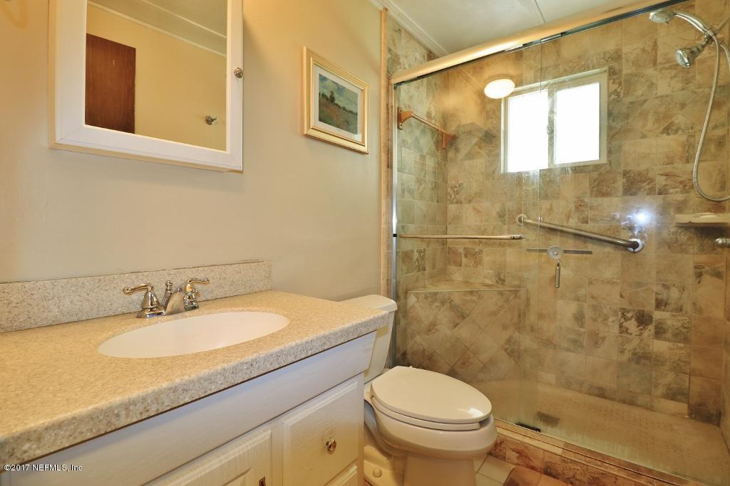 10414 Stone Road Jacksonville, FL 32246 - Photo 16 of 23 a bathroom with a granite countertop sink toilet and shower