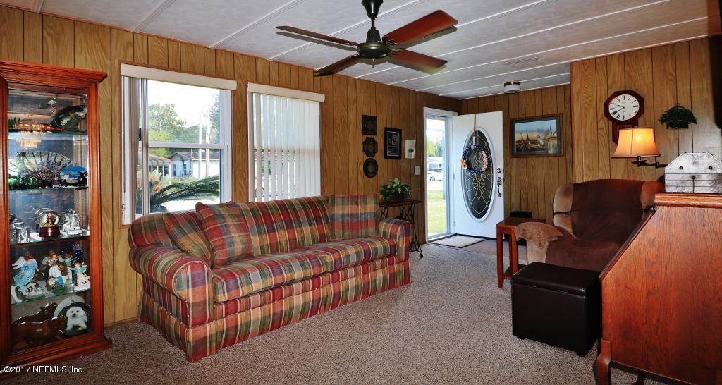10414 Stone Road Jacksonville, FL 32246 - Photo 6 of 23 a living room with furniture and a window