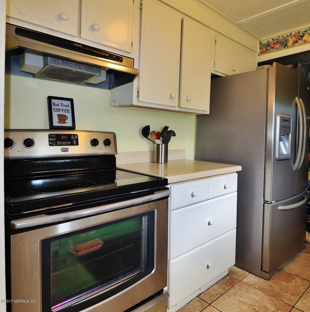 10414 Stone Road Jacksonville, FL 32246 - Photo 9 of 23 a kitchen with stainless steel appliances a stove and a refrigerator