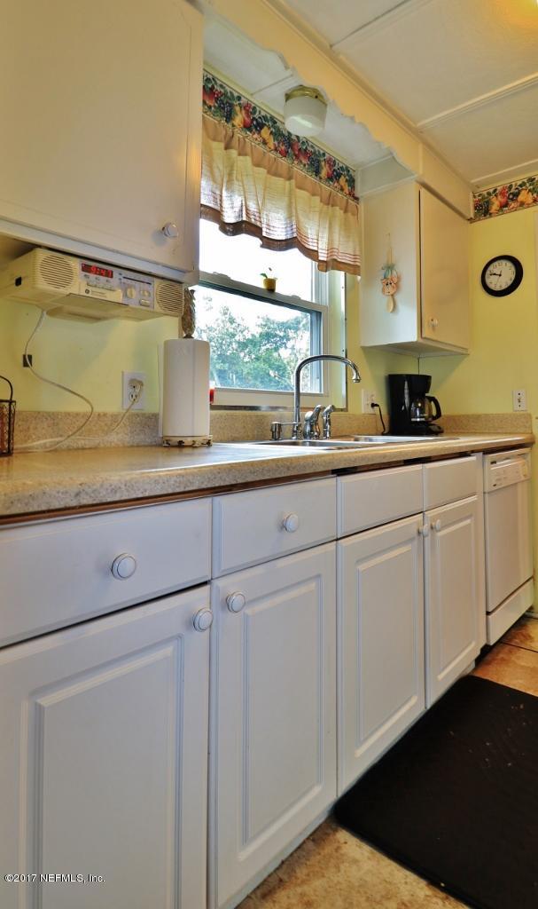 10414 Stone Road Jacksonville, FL 32246 - Photo 10 of 23 a kitchen with cabinets and window