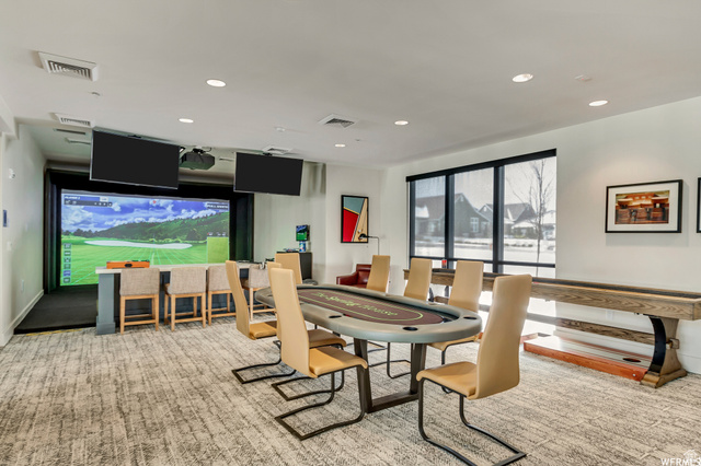 11508 Kitty Hawk Road South Jordan, UT 84009 - Photo 37 of 38 Dedicated entertainment space featuring a golf simulator, a built-in bar with seating, a large poker table, and a shuffleboard table