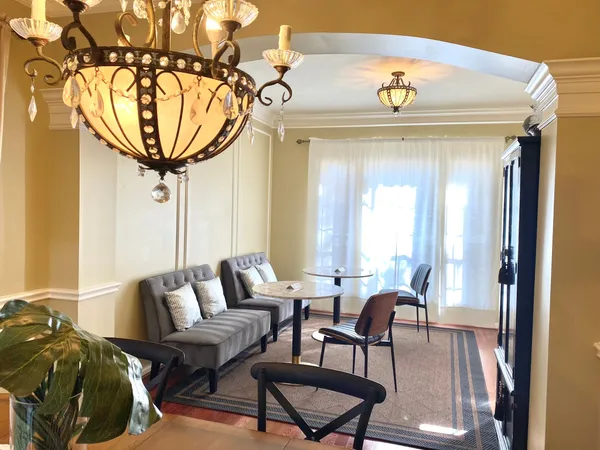 a view of a dining room with furniture and a chandelier
