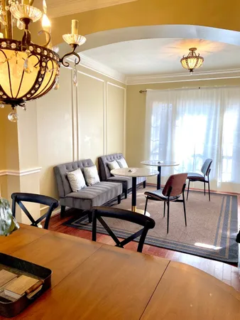 a living room with furniture and a floor to ceiling window