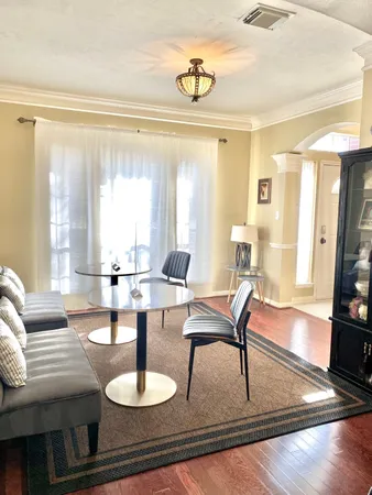 a view of a dining room with furniture and chandelier