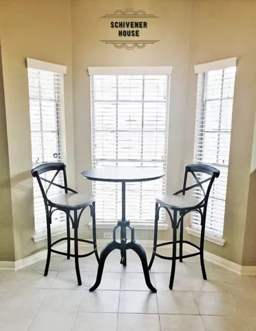 a view of a dining room with furniture and a window