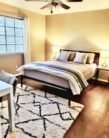 a bed sitting in a bedroom next to a window