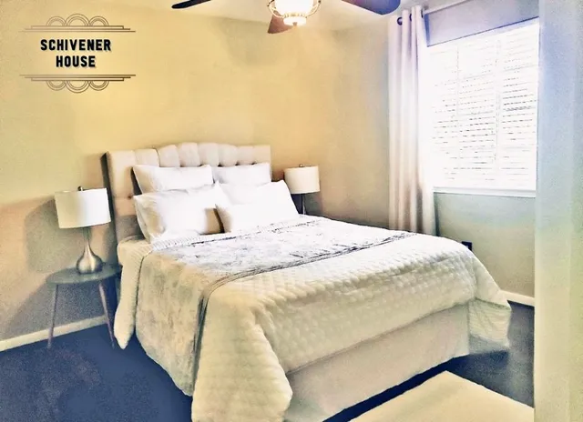 a bedroom with bed and window