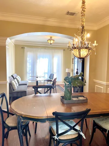 a view of a dining room with furniture and chandelier