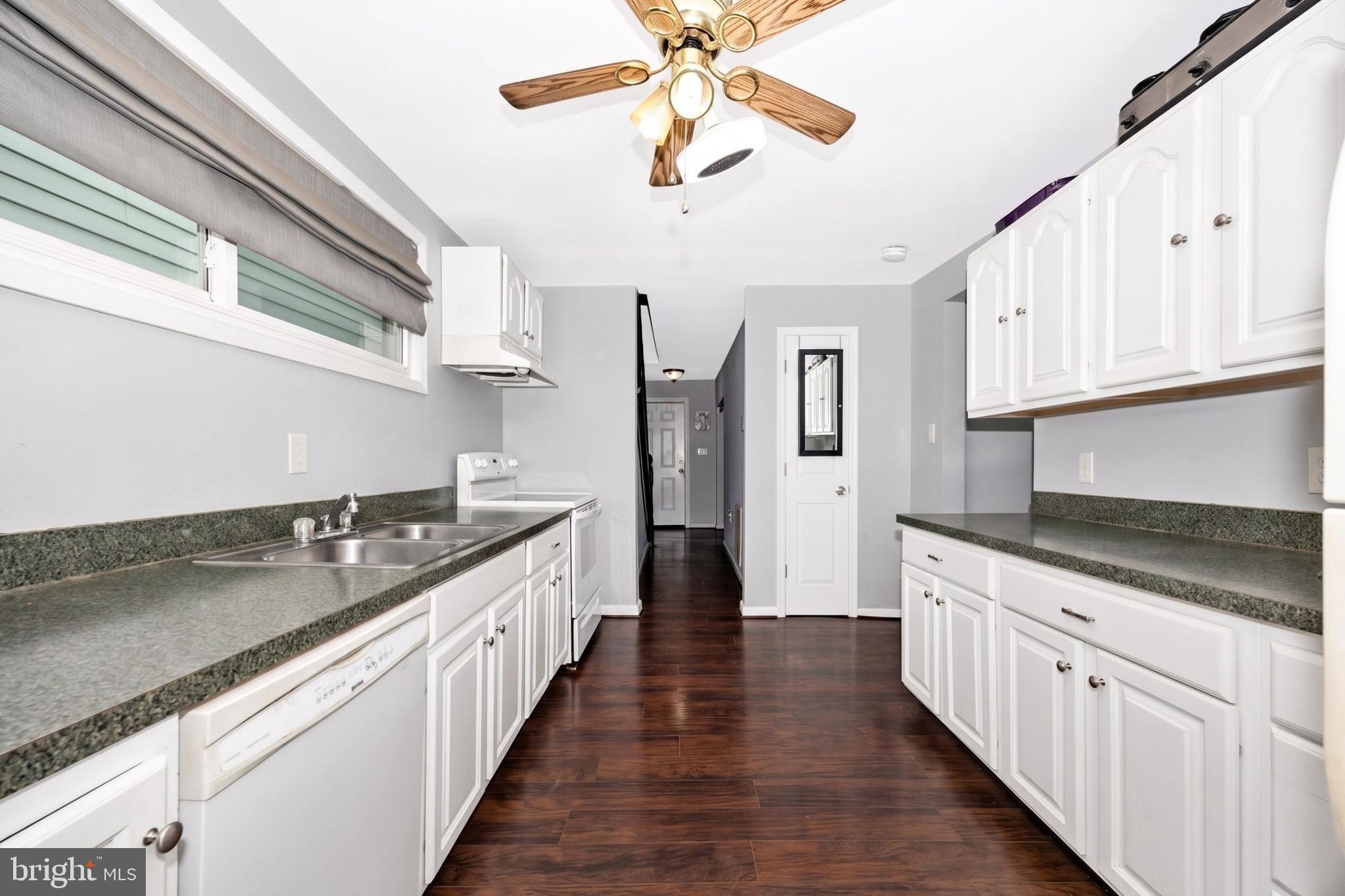 808 Knoxville Road Knoxville, MD 21758 - Photo 3 of 14 a kitchen with stainless steel appliances granite countertop a sink and dishwasher a stove top oven with wooden floor