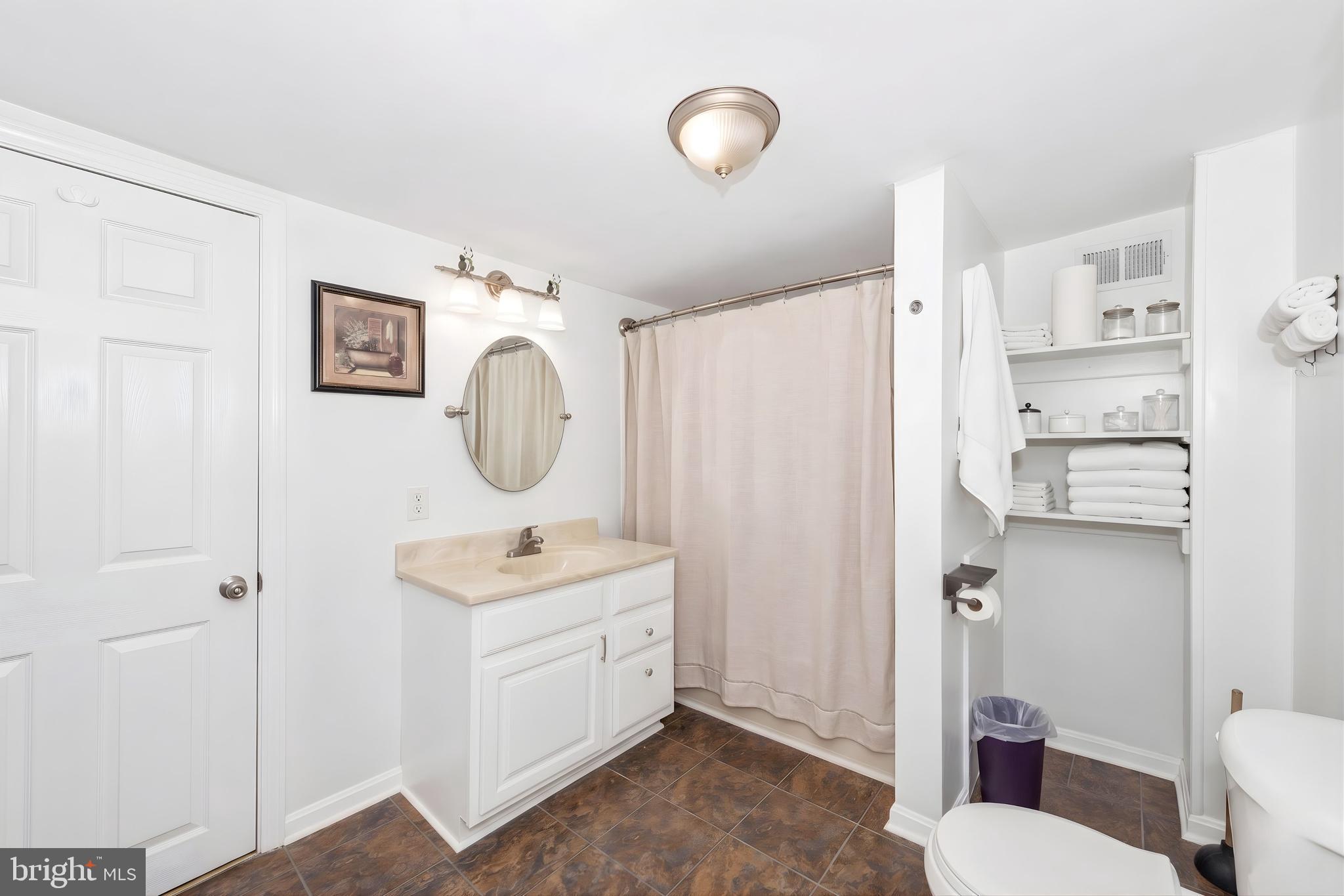 808 Knoxville Road Knoxville, MD 21758 - Photo 8 of 14 a bathroom with a toilet sink vanity and mirror
