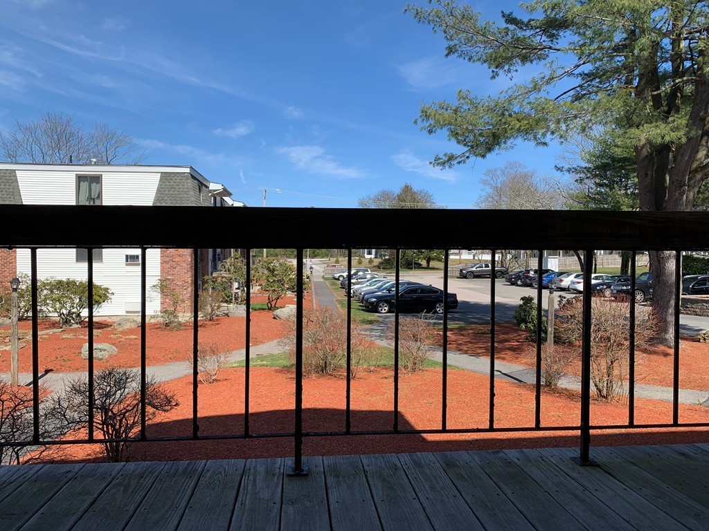 96 Main Street, Unit C4 Foxboro, MA 02035 - Photo 12 of 14 a view of roof deck with wooden floor and floor to ceiling window