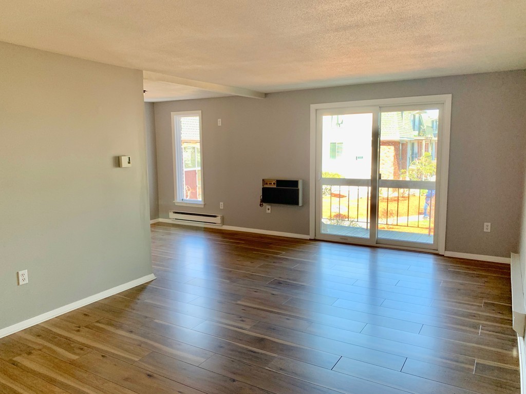 96 Main Street, Unit C4 Foxboro, MA 02035 - Photo 3 of 14 a view of a livingroom with wooden floor and a window