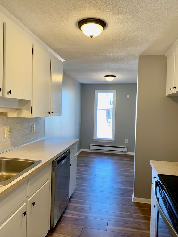96 Main Street, Unit C4 Foxboro, MA 02035 - Photo 8 of 14 a kitchen with wooden floors and a sink