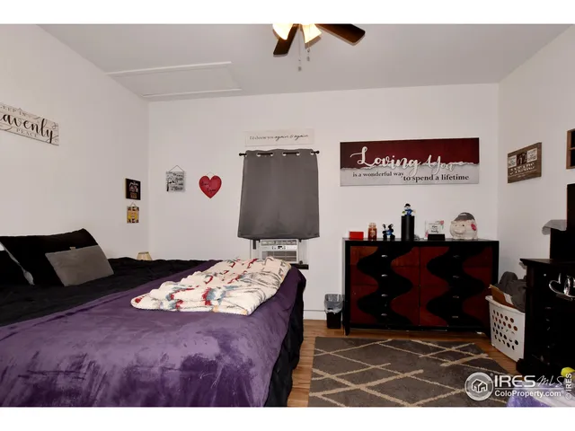 a bed room with two beds and a television