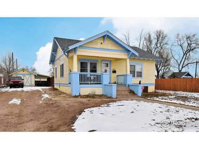 a view of a house with a yard covered in snow