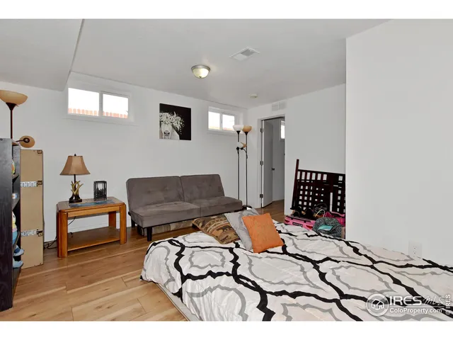 a bedroom with furniture and a wooden floor
