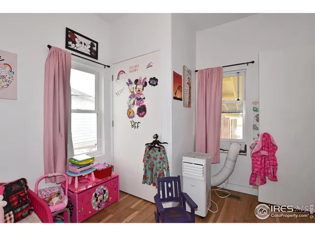 a bedroom with furniture and a window