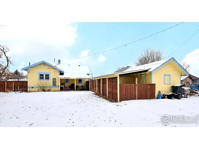 a front view of a house with a yard covered in snow
