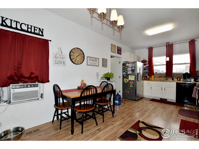 a view of a dining room with furniture and chandelier