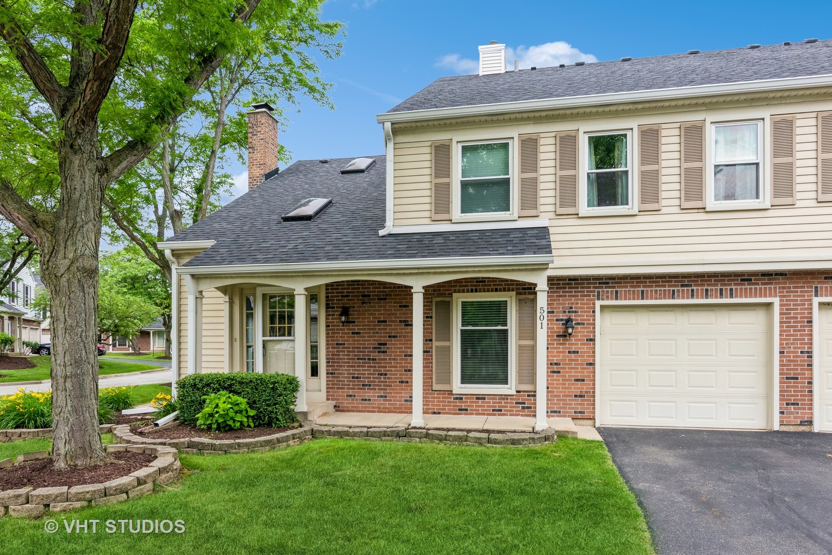 501 Crossing Court Rolling Meadows, IL 60008 - Photo 1 of 14 a view of a brick house with a yard potted plants and a large tree