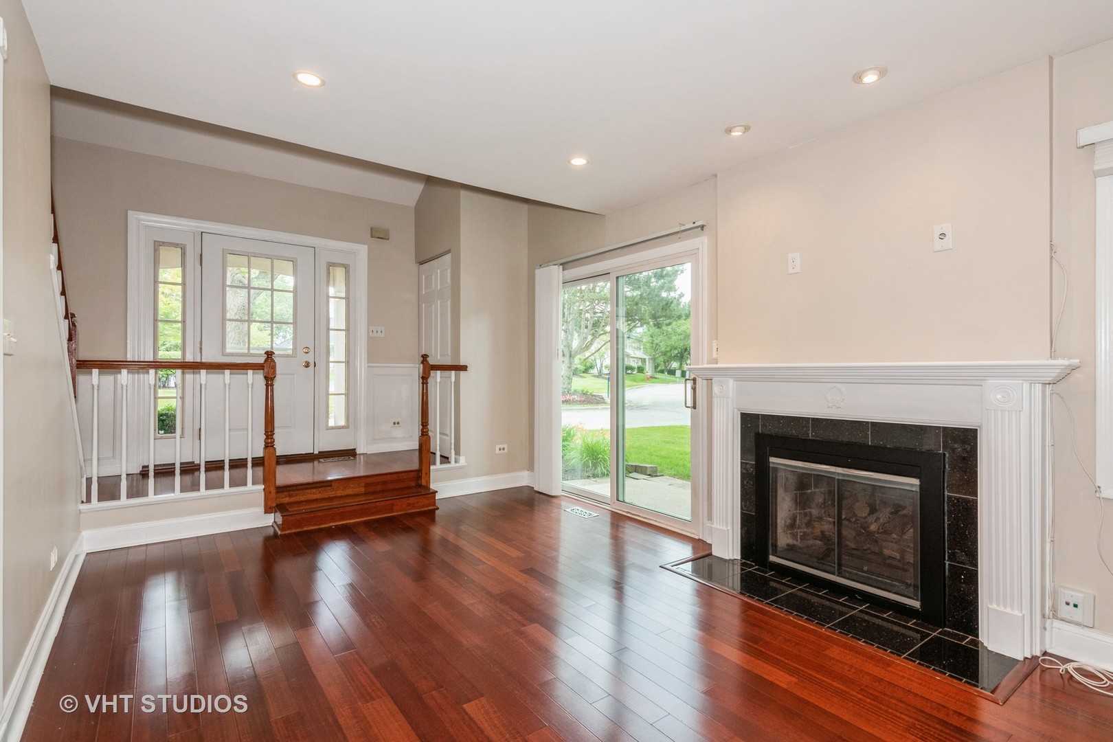 501 Crossing Court Rolling Meadows, IL 60008 - Photo 3 of 14 an empty room with wooden floor fireplace and windows
