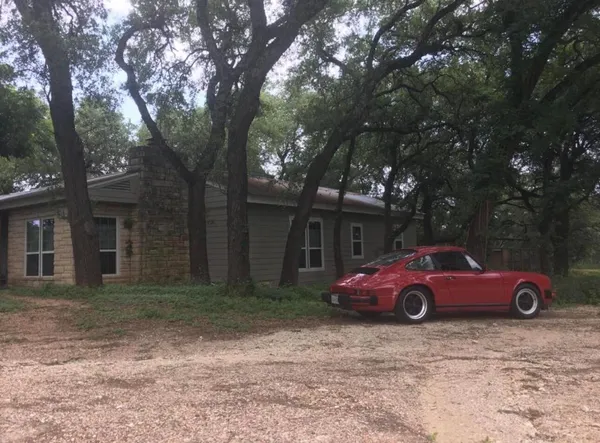 a tall tree in front of a house