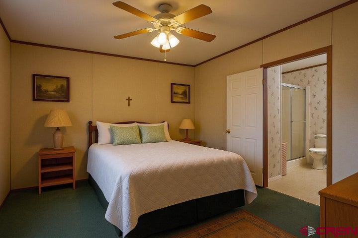 24900 Hilltop Road Trinidad, CO 81082 - Photo 11 of 17 a bedroom with a bed and a chandelier