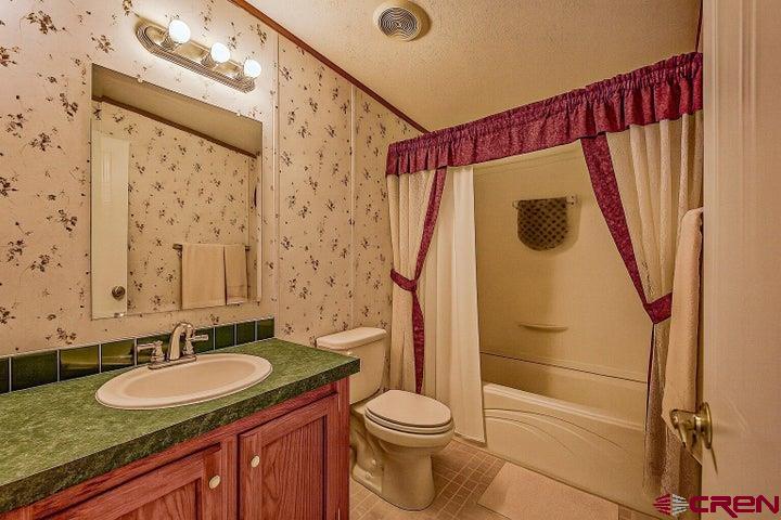 24900 Hilltop Road Trinidad, CO 81082 - Photo 14 of 17 a bathroom with a granite countertop sink and a mirror