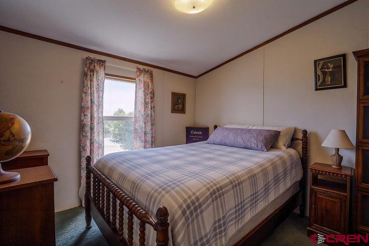 24900 Hilltop Road Trinidad, CO 81082 - Photo 16 of 17 a bedroom with a bed next to a window