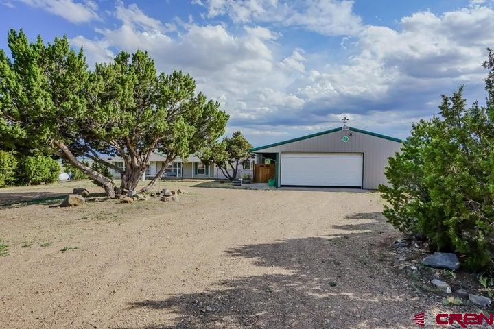 24900 Hilltop Road Trinidad, CO 81082 - Photo 17 of 17 a front view of a house with a yard and garage
