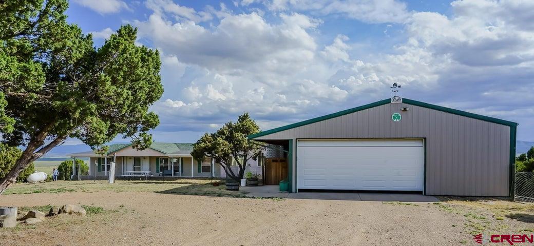 24900 Hilltop Road Trinidad, CO 81082 - Photo 2 of 17 a front view of a house with a garden