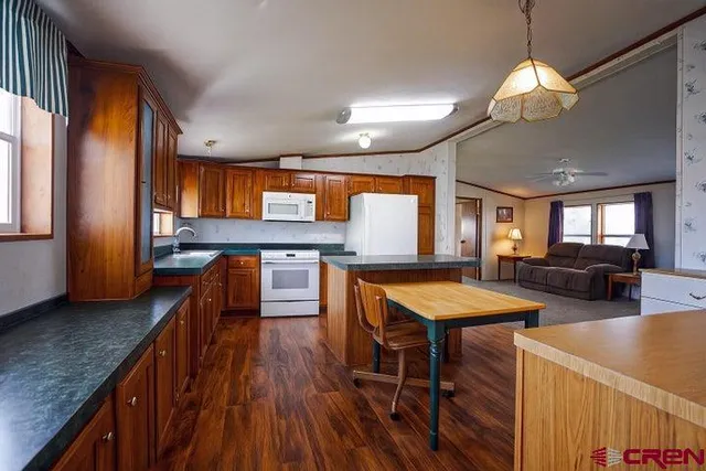 a kitchen with stainless steel appliances granite countertop sink stove top oven and cabinets