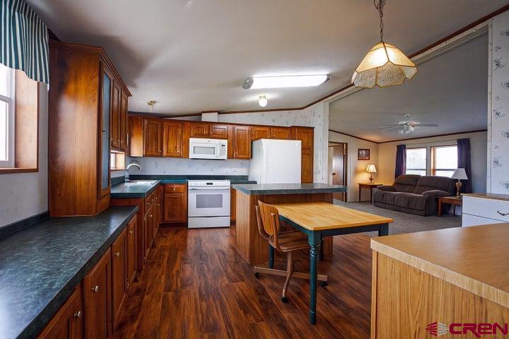 24900 Hilltop Road Trinidad, CO 81082 - Photo 5 of 17 a kitchen with stainless steel appliances granite countertop sink stove top oven and cabinets