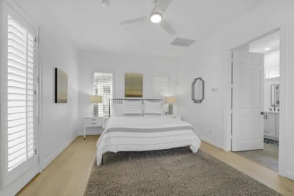 a bedroom with a bed lamp closet and window