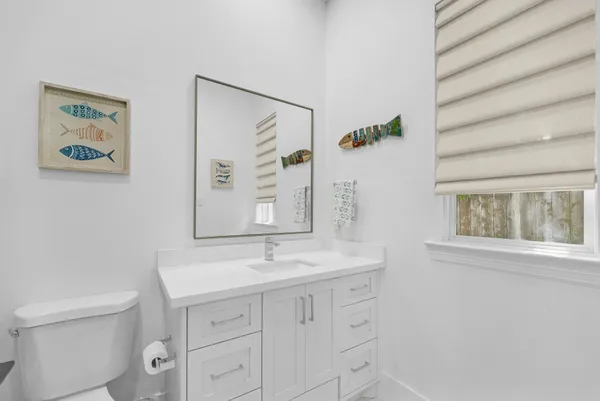 a bathroom with a sink a mirror and a toilet