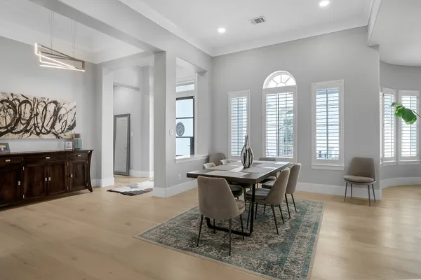a view of a a dining room with furniture window and wooden floor